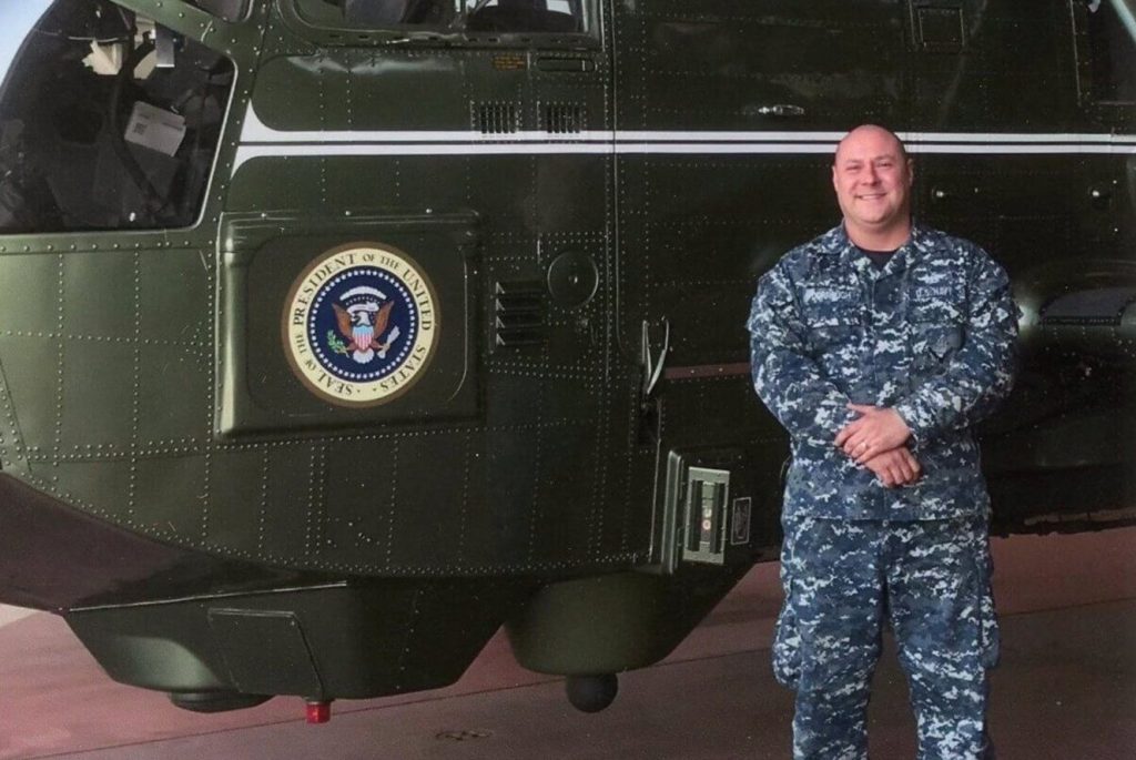 Lincoln Dorrough standing in front of helicopter