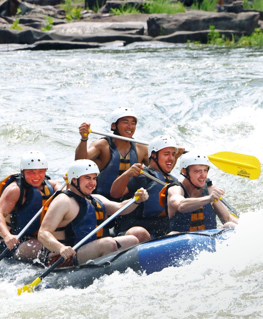 group of men white water rafting