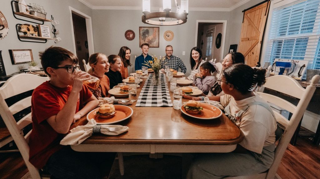 family sitting down to eat dinner together