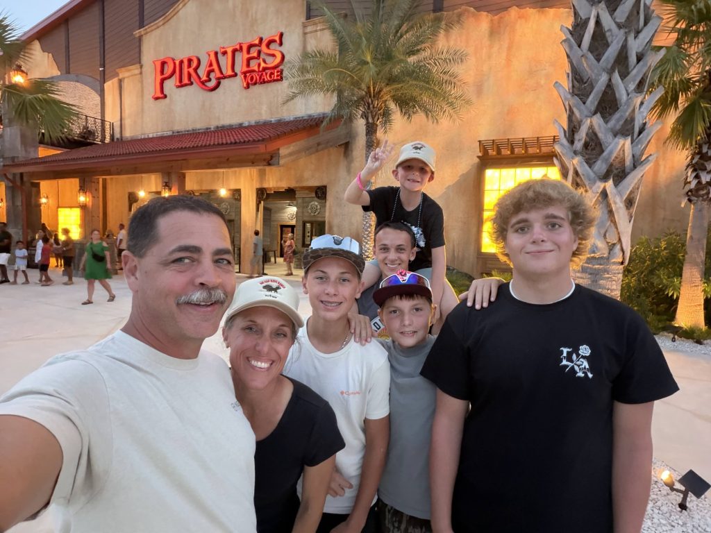 A Ranch family smiles together for a photo during a beach trip outing.